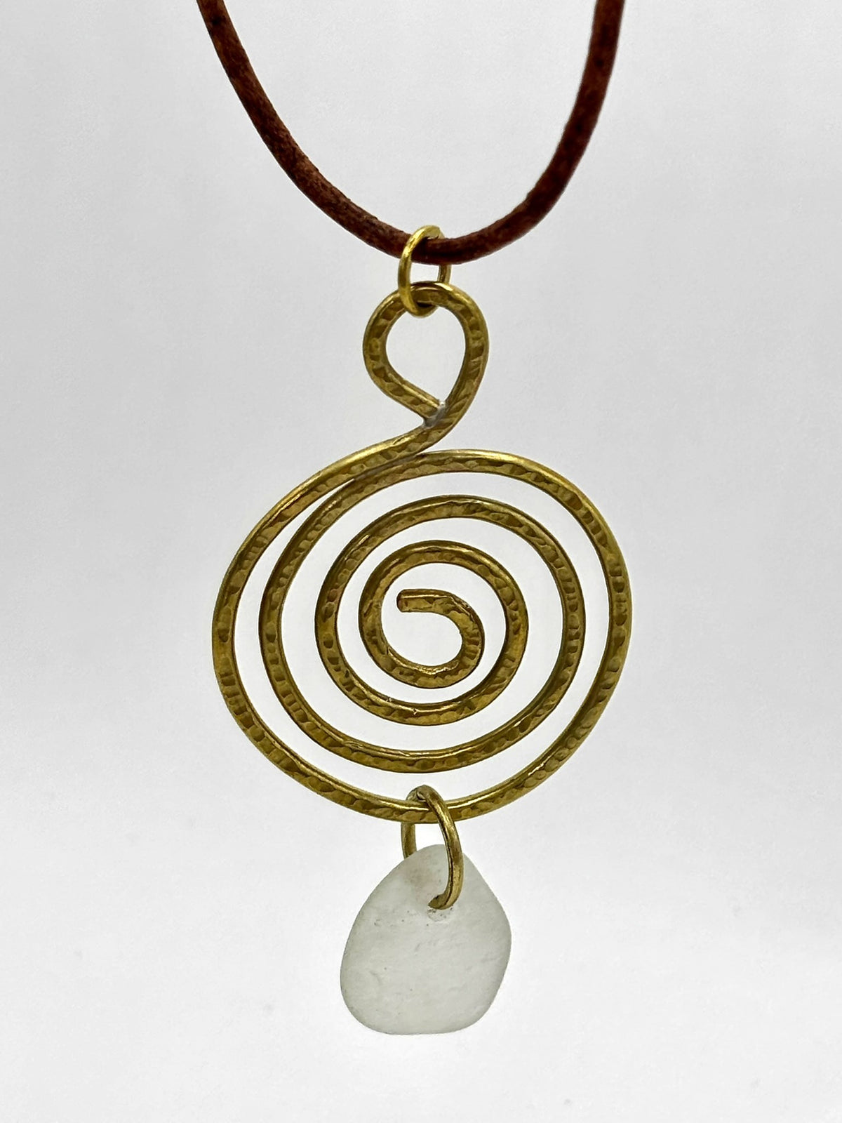 Brass whirlpool and sea glass pendant