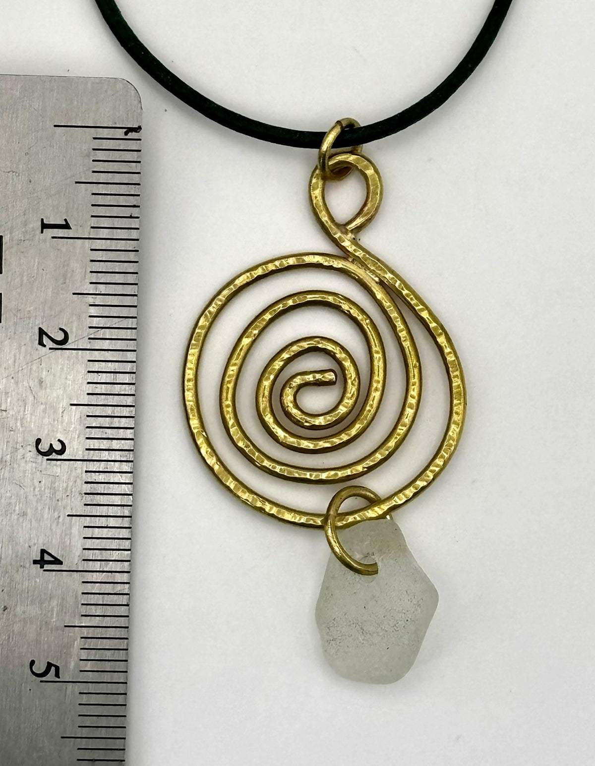Brass whirlpool and sea glass pendant